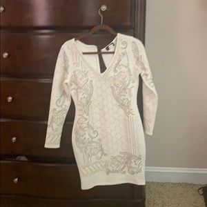 Long sleeved white dress with gold beading